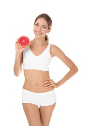 Photo of Happy slim woman in underwear holding grapefruit on white background. Weight loss diet