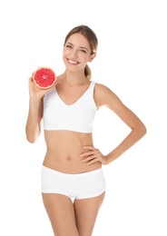 Happy slim woman in underwear holding grapefruit on white background. Weight loss diet