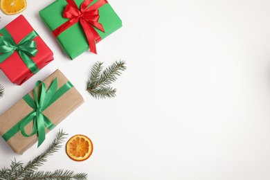 Composition with Christmas gifts on white background, top view