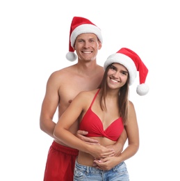 Photo of Happy couple with Santa hats together on white background. Christmas vacation