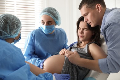 Photo of Woman giving child birth in maternity hospital