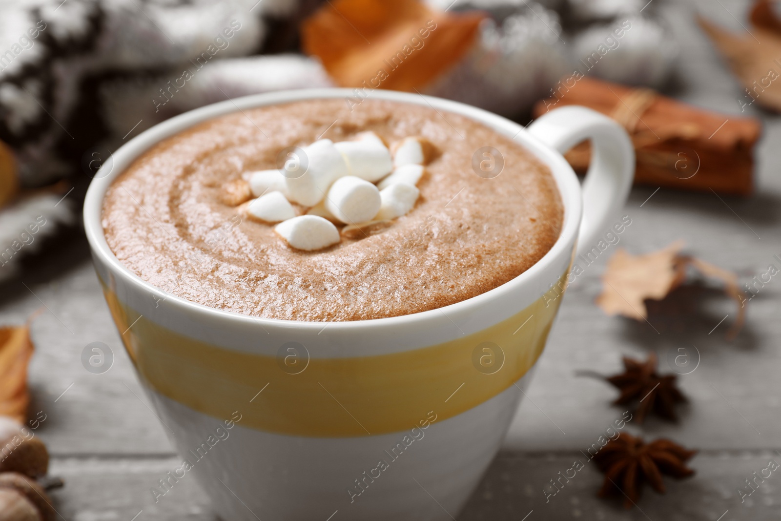 Photo of Cup of hot drink on grey wooden table, closeup. Cozy autumn atmosphere