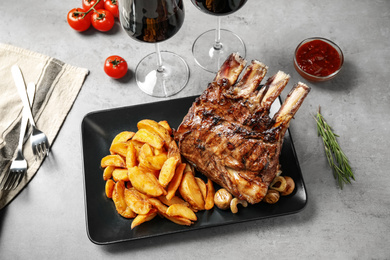Delicious grilled ribs served on light grey table