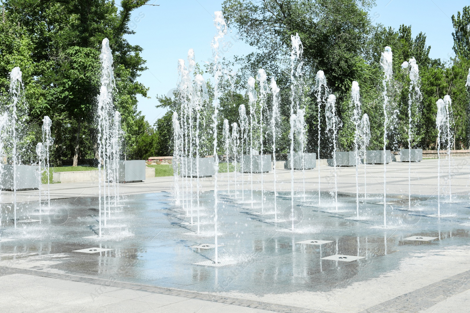 Photo of City square with beautiful fountains on sunny day