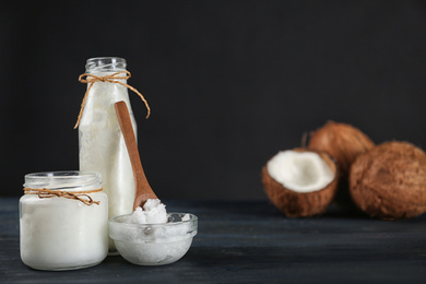 Photo of Fresh coconut oil on dark wooden table, space for text. Cooking ingredient