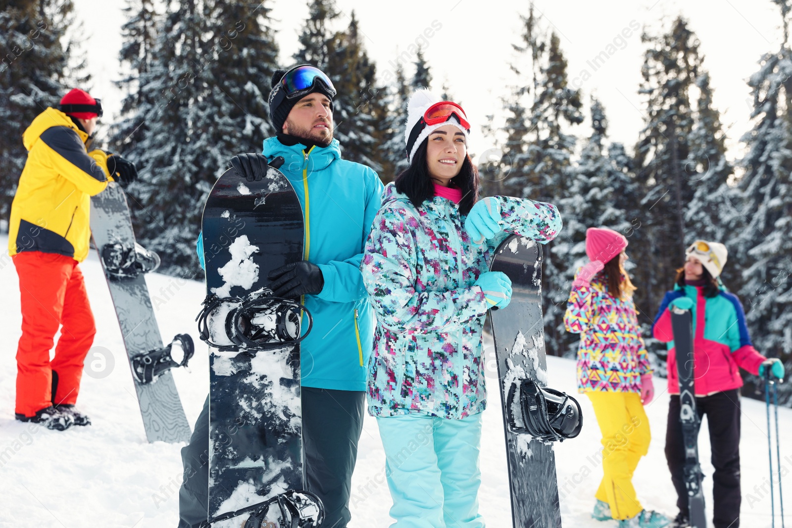 Photo of Happy couple with equipment at ski resort. Winter vacation