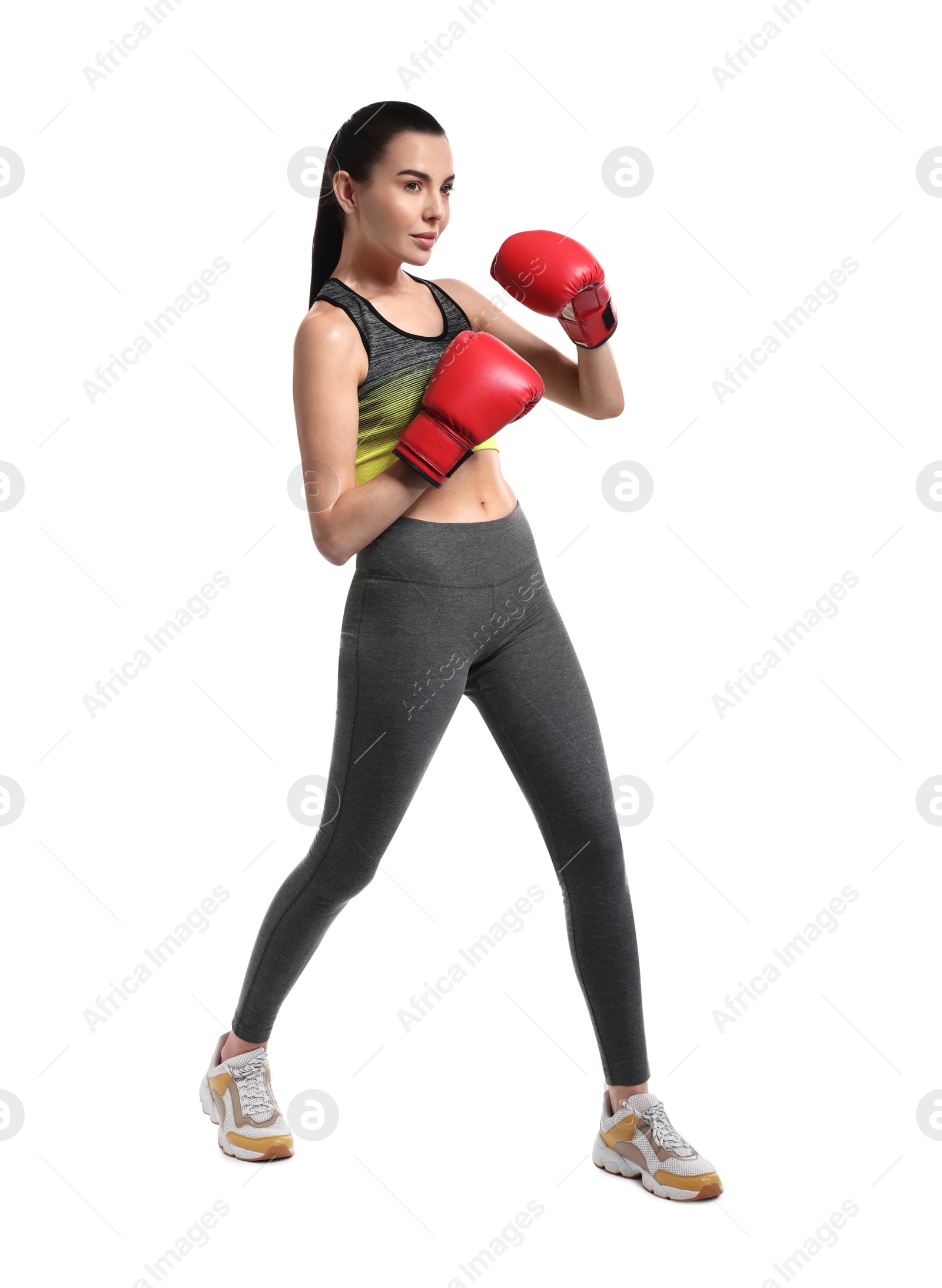 Photo of Beautiful woman in boxing gloves training on white background