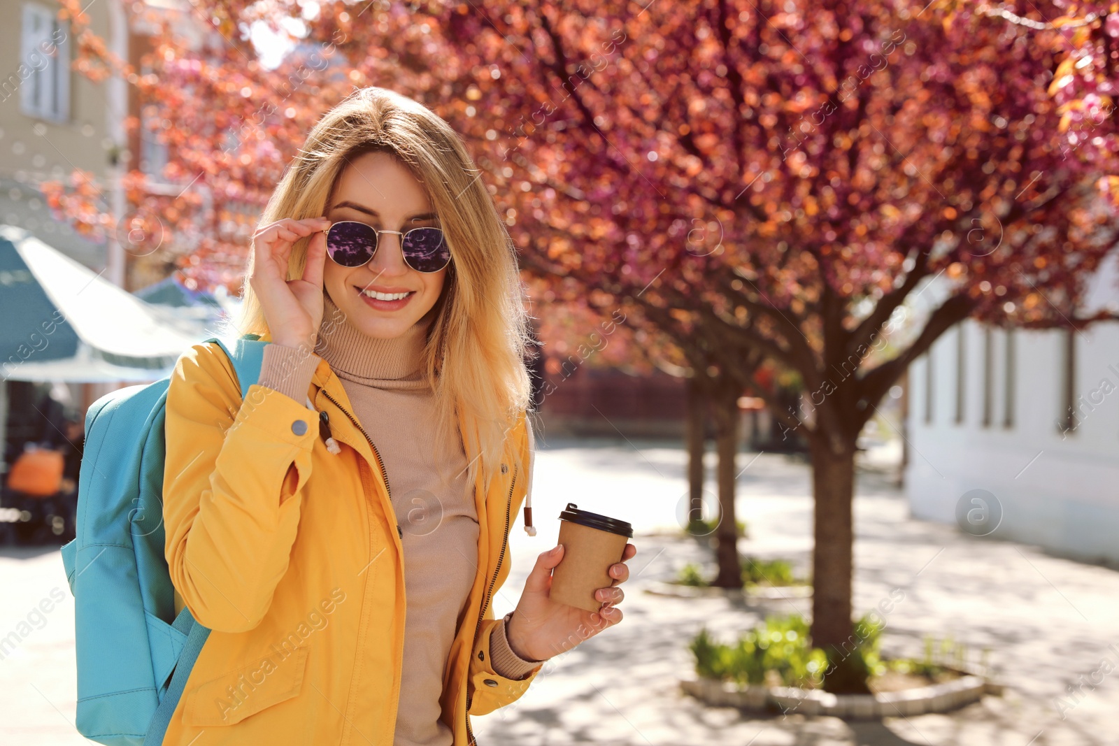 Photo of Tourist with cup of coffee on city street