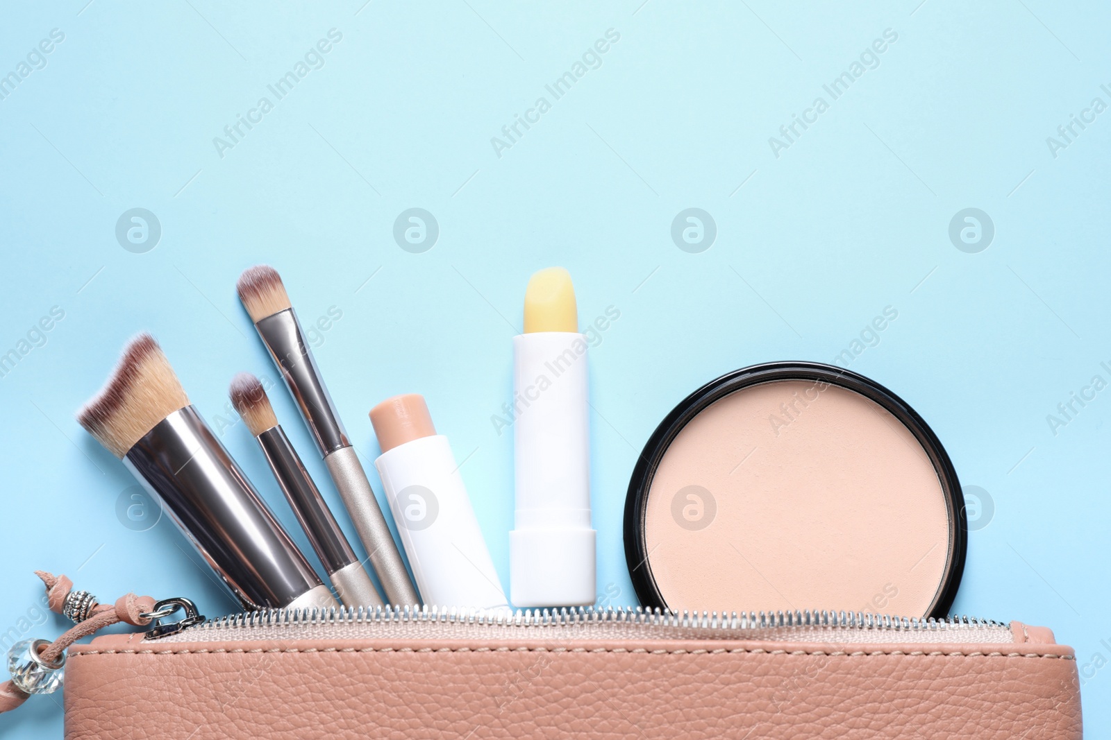 Photo of Flat lay composition with hygienic lipsticks on light blue background
