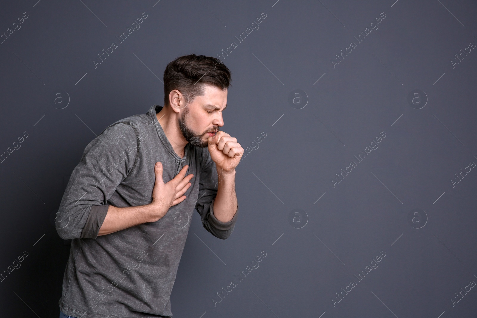 Photo of Mature man coughing on color background