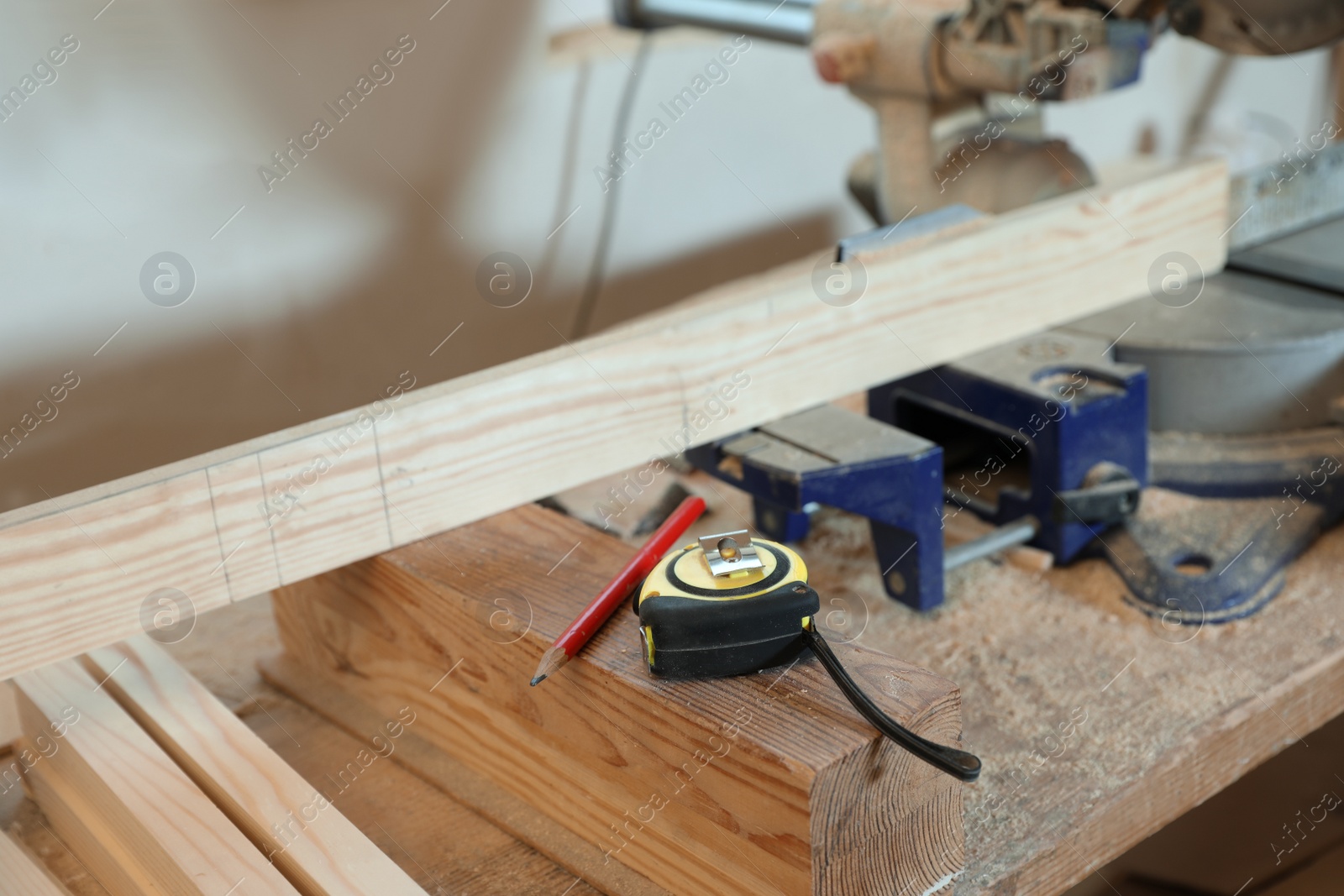 Photo of Carpenter's working place with instruments and timber indoors