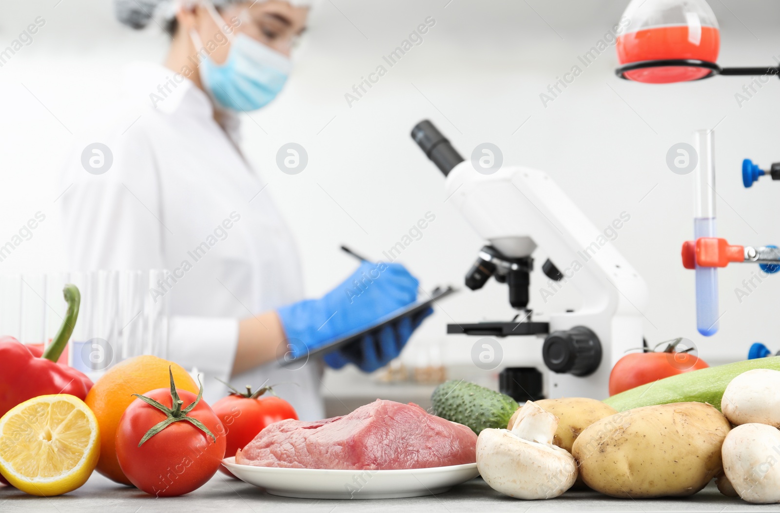 Photo of Different products on table and scientist in laboratory. Quality control