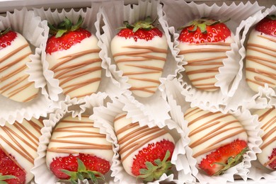 Photo of Delicious chocolate covered strawberries in box, top view