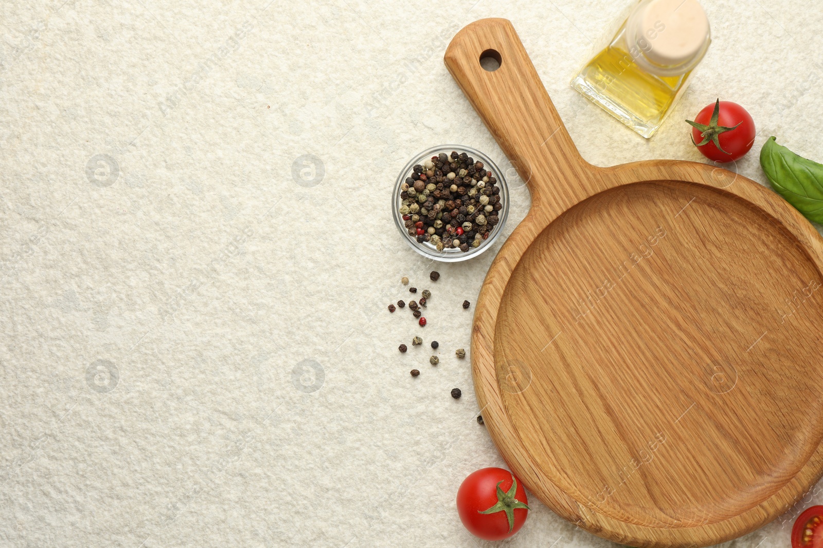 Photo of Cutting board, basil, oil, spices and tomatoes on white textured table, flat lay. Space for text