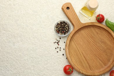 Photo of Cutting board, basil, oil, spices and tomatoes on white textured table, flat lay. Space for text