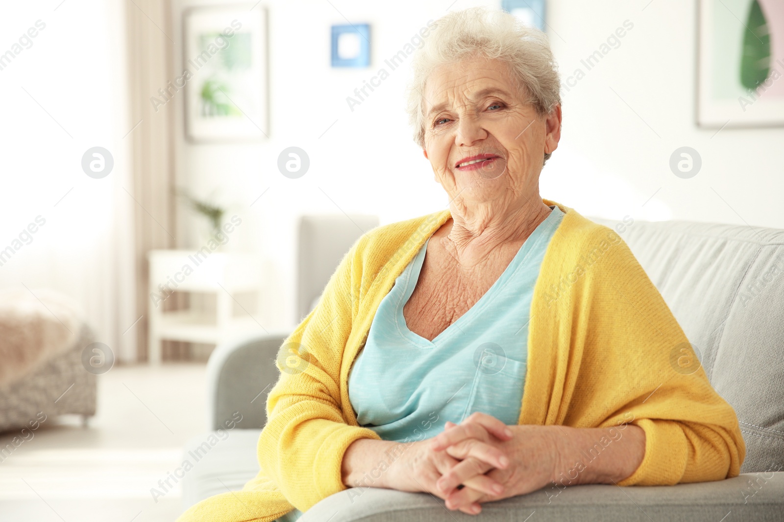 Photo of Elderly woman sitting on couch in living room