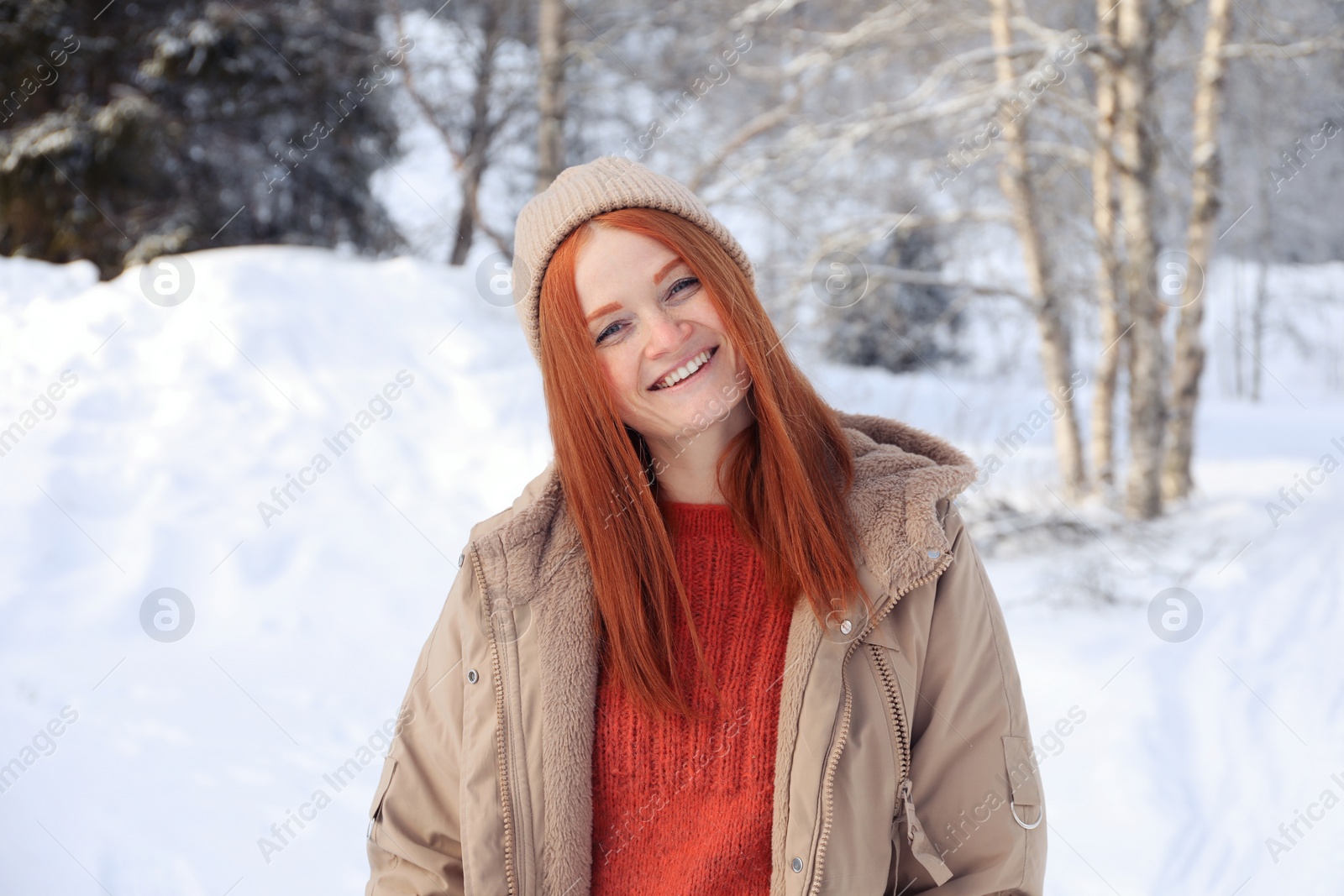 Photo of Portrait of beautiful young woman on snowy day outdoors. Winter vacation