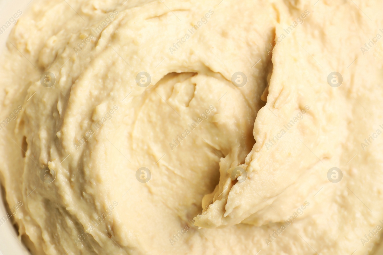 Photo of Classic tasty hummus as background, top view