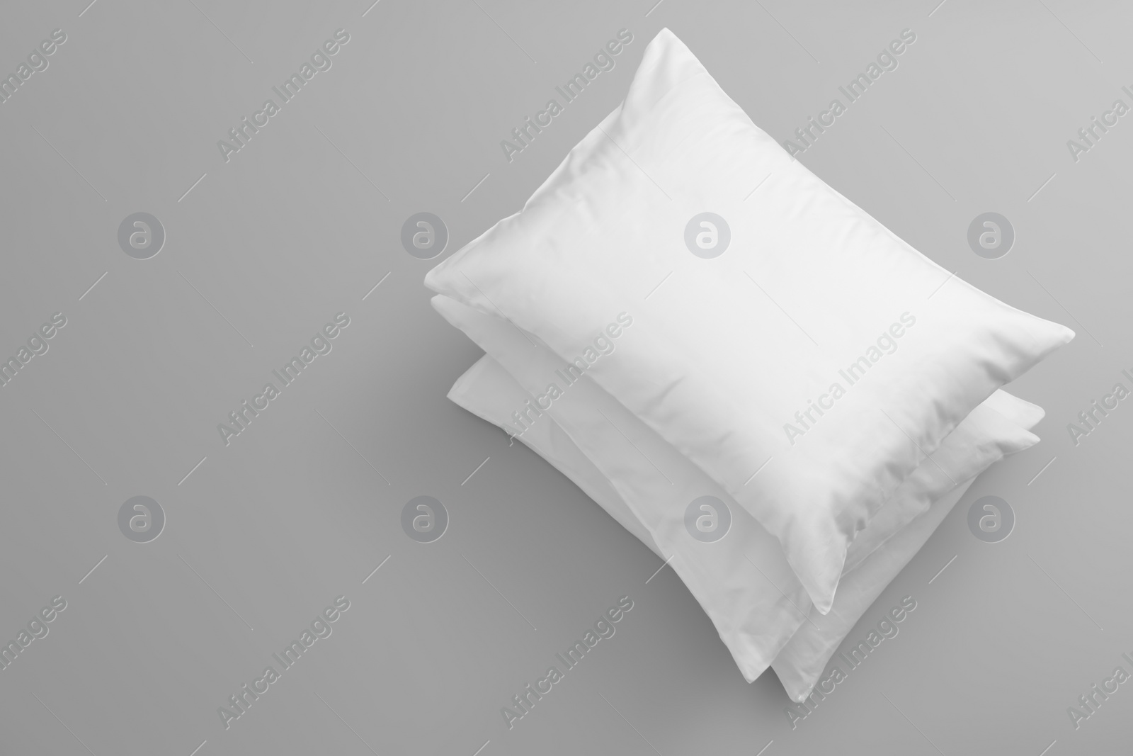 Photo of Clean soft bed pillows on grey background, top view