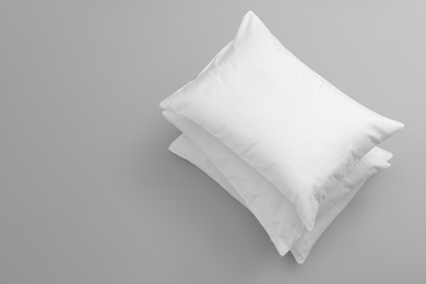 Photo of Clean soft bed pillows on grey background, top view