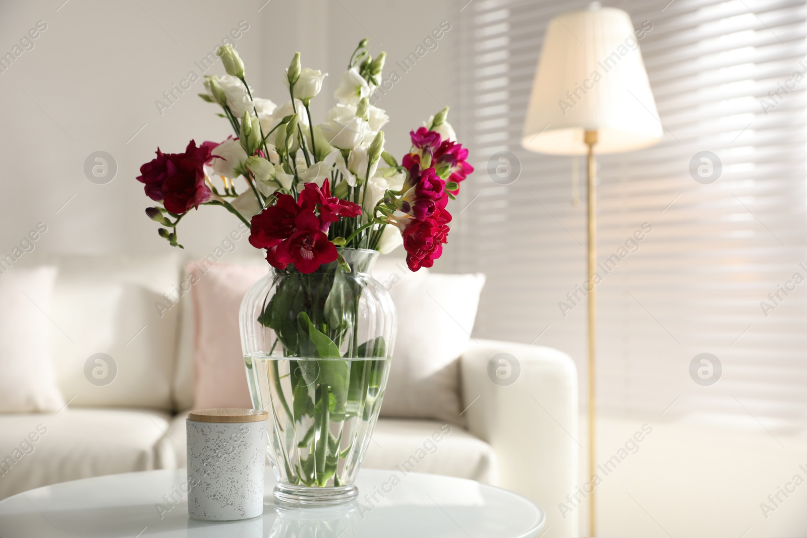 Photo of Beautiful bouquet with spring freesia flowers in light room