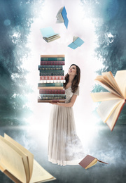 Beautiful woman with stack of books in foggy forest