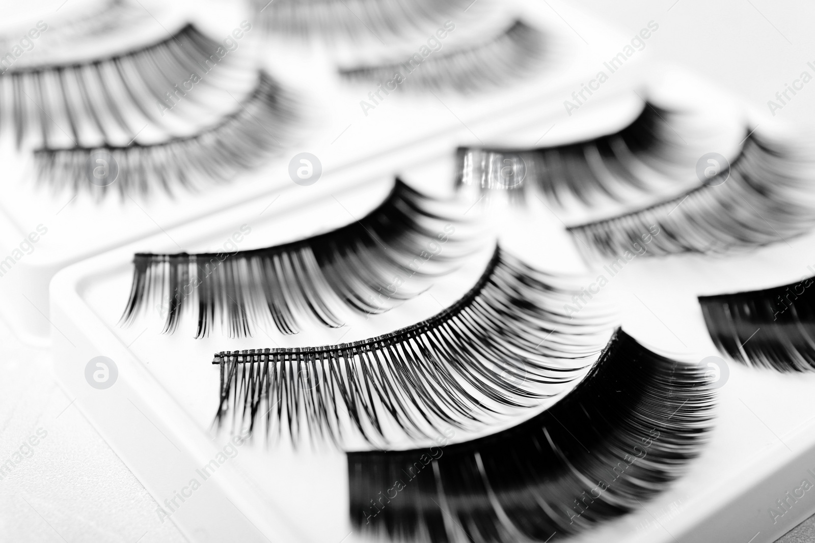 Photo of Different types of false eyelashes in pack, closeup