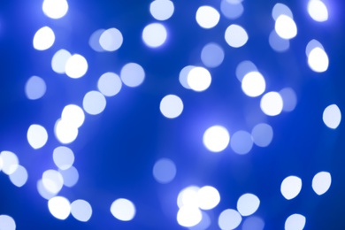 Photo of Blurred view of beautiful lights on blue background