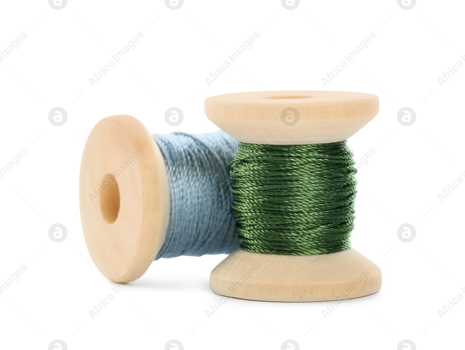 Photo of Different colorful sewing threads on white background