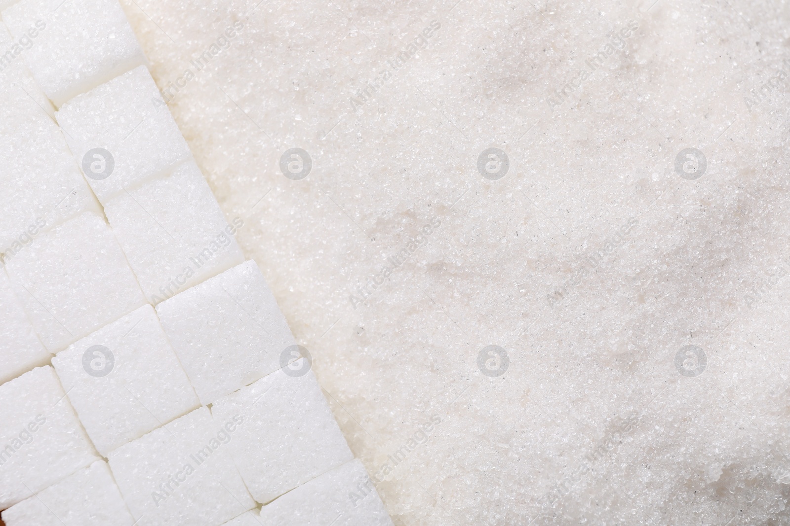 Photo of Different types of white sugar as background, top view. Space for text