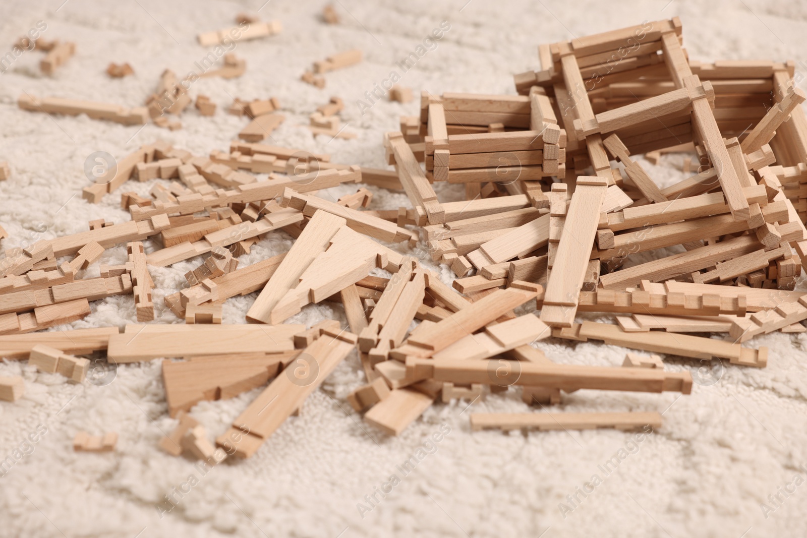 Photo of Wooden construction set on carpet indoors. Children's toy