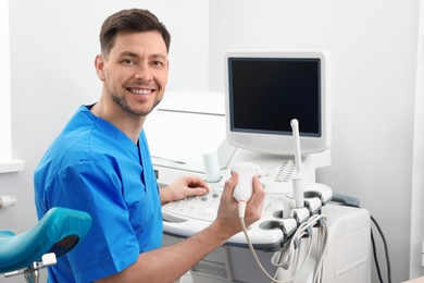 Photo of Sonographer operating modern ultrasound machine in clinic