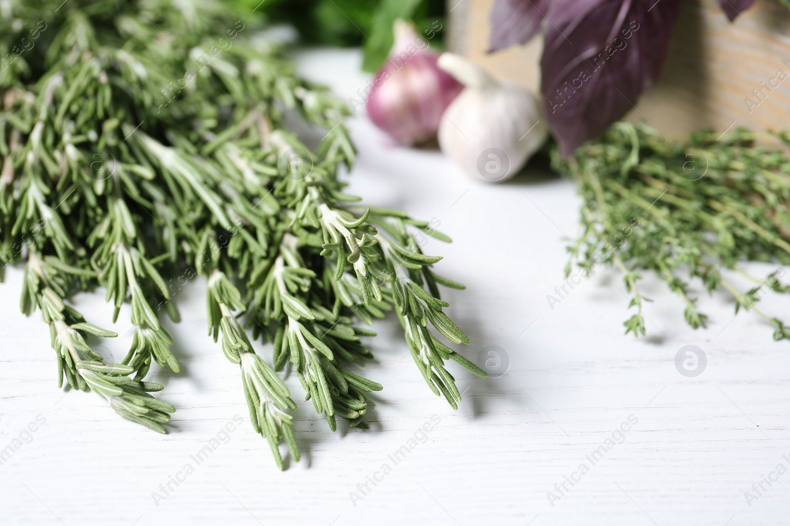 Photo of Rosemary and other aromatic herbs on wooden table