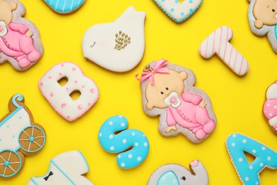 Set of baby shower cookies on yellow background, flat lay