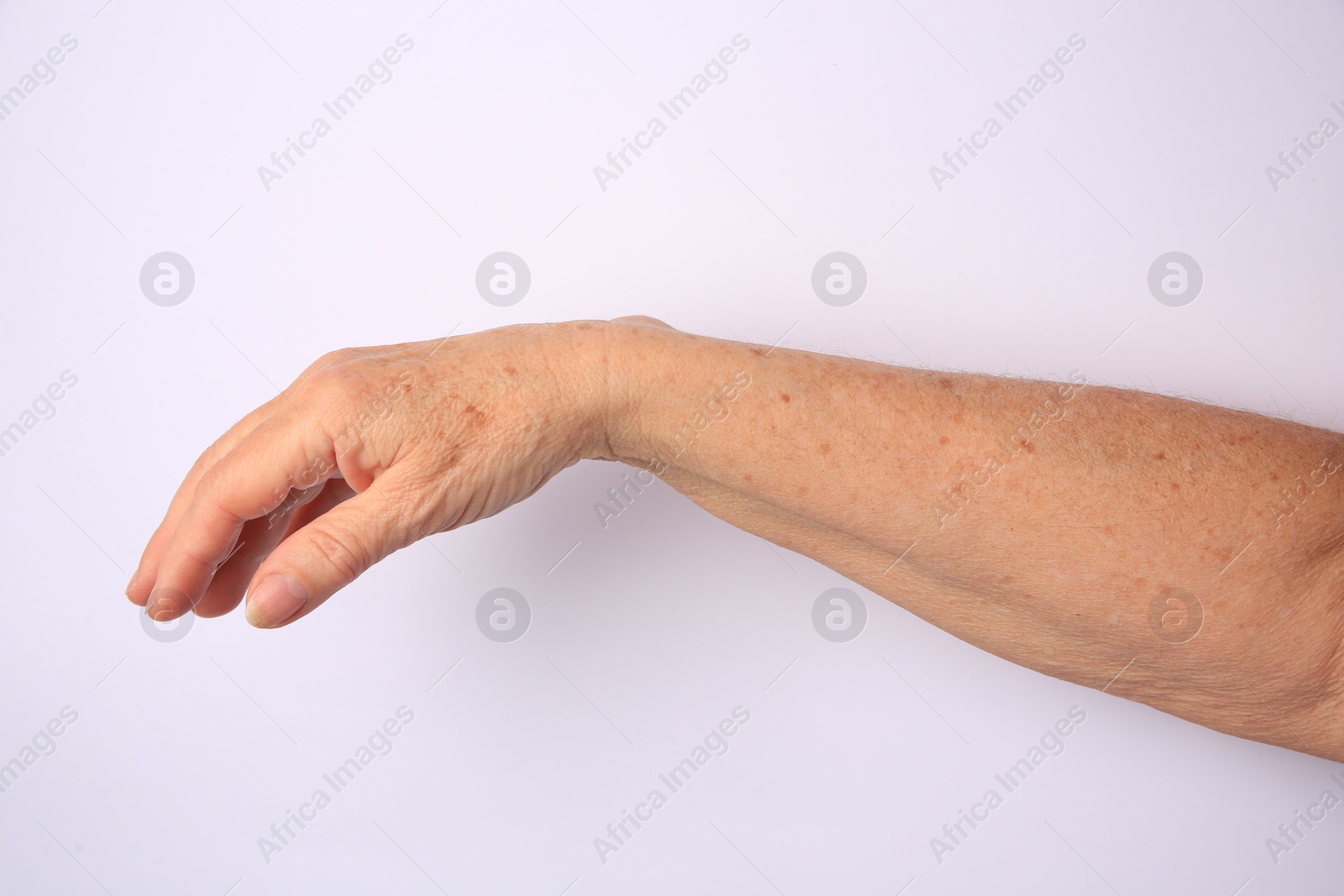 Photo of Closeup view of older woman's hand on white background