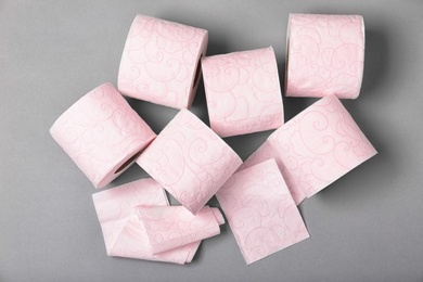 Photo of Rolls of toilet paper on grey background, top view. Personal hygiene