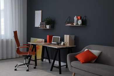 Photo of Modern workplace with comfortable chair in stylish home office interior