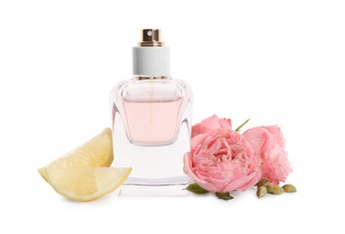 Photo of Bottle of perfume, lemon and flowers on white background