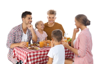 Happy family having picnic at table on white background