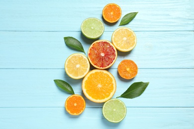 Photo of Flat lay composition with different citrus fruits on wooden background