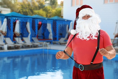 Photo of Authentic Santa Claus near pool at resort