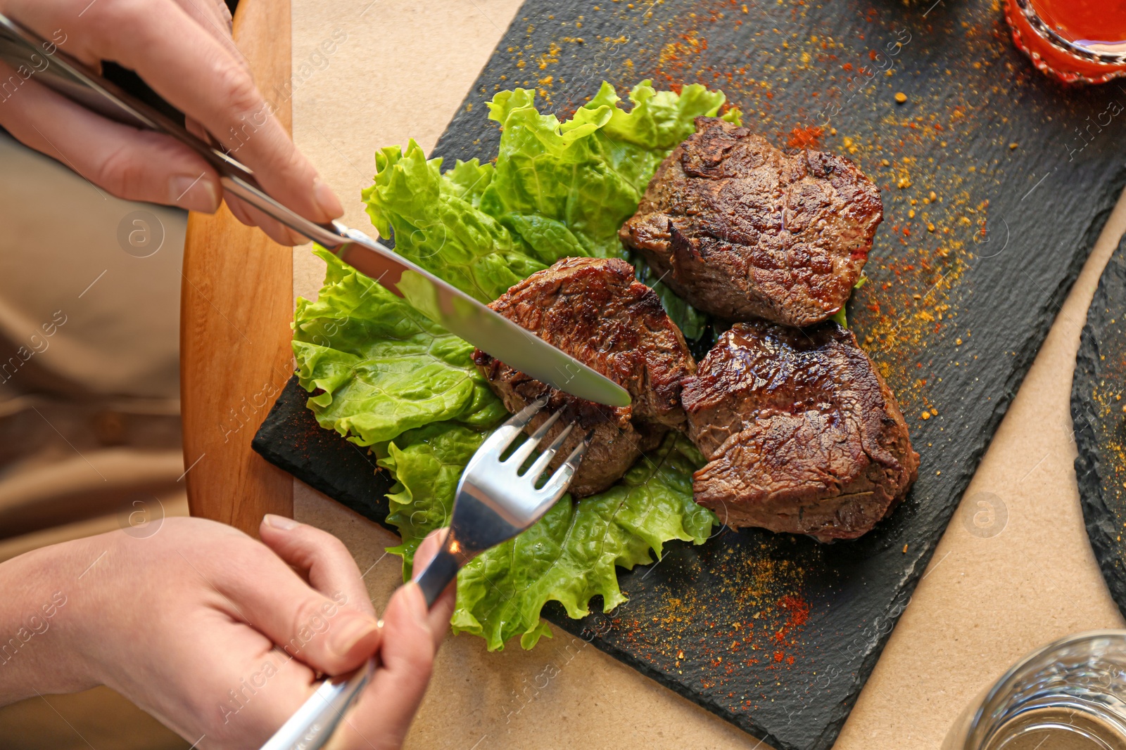 Photo of Woman eating tasty shish kebab in cafe