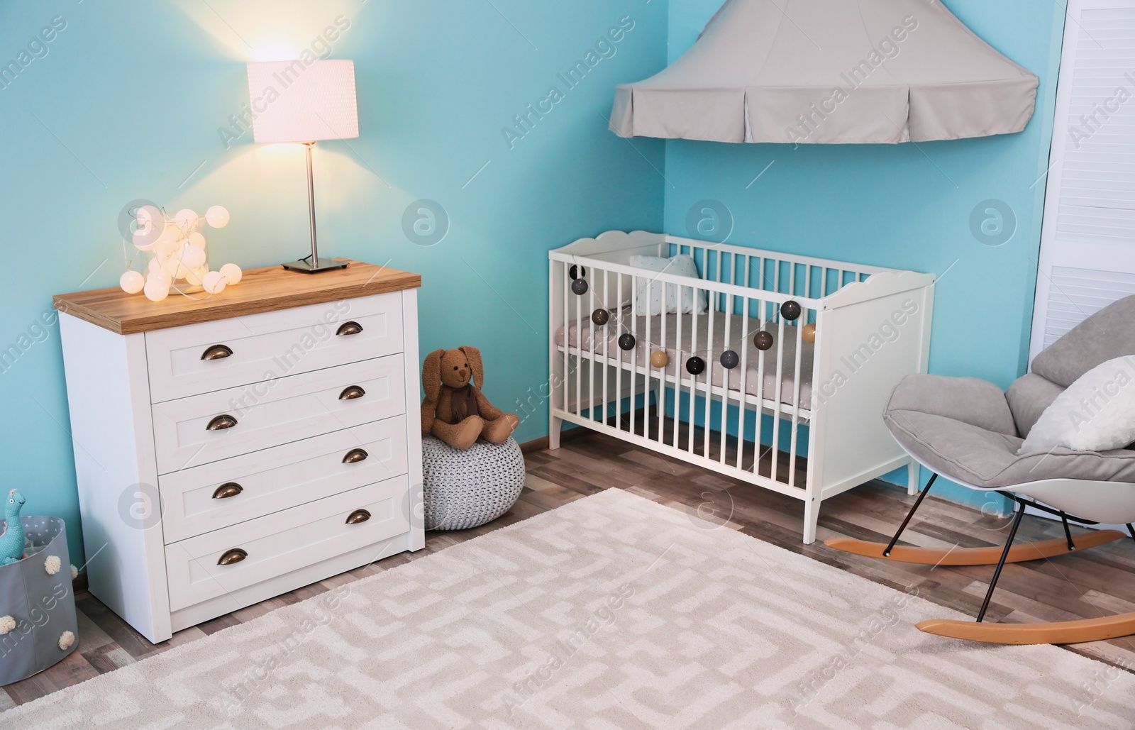 Photo of Modern interior of light cozy baby room with crib