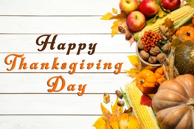 Image of Happy Thanksgiving Day card. Flat lay composition with ripe pumpkins and autumn leaves on white wooden table