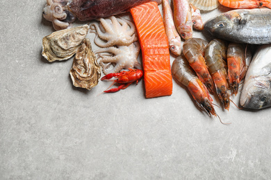 Photo of Fresh fish and seafood on marble table, flat lay. Space for text