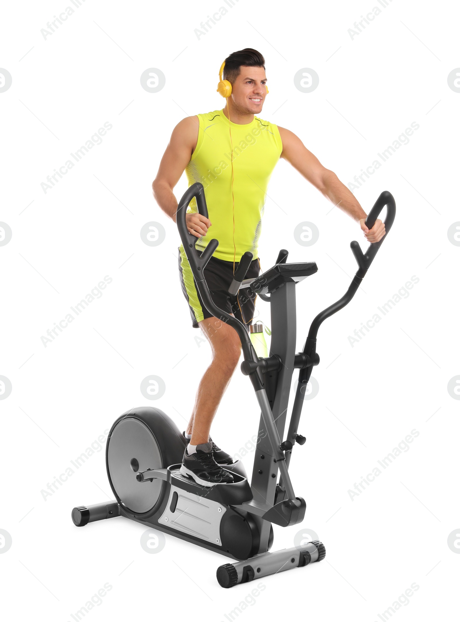 Photo of Man using modern elliptical machine on white background