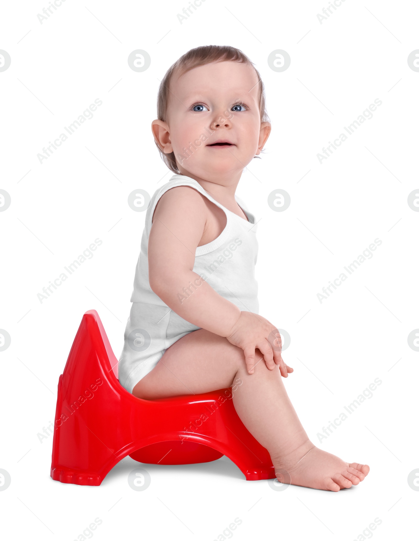 Photo of Little child sitting on baby potty against white background