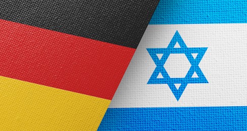 International relations. National flags of Germany and Israel on textured surface, banner design