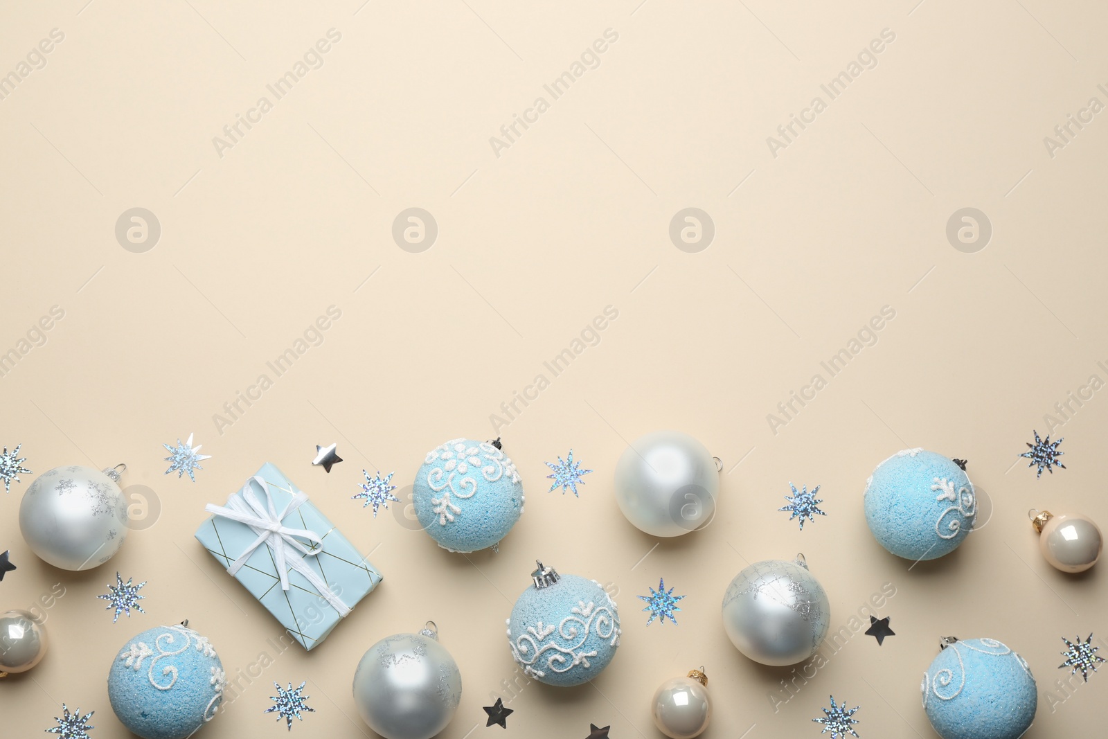 Photo of Flat lay composition with Christmas decorations on beige background, space for text. Winter season