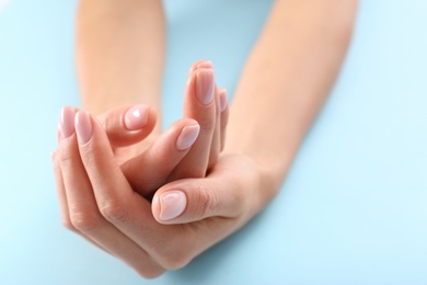 Photo of Closeup view of woman with beautiful hands on color background. Spa treatment